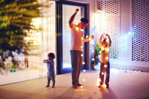 A family removing outdoor holiday lights in Houston, TX.