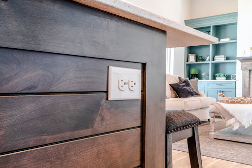 A kitchen island with two outlets.