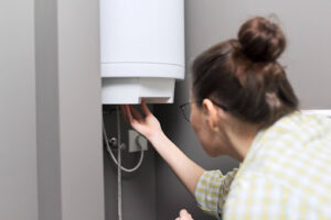 Woman checking her tankless water heater