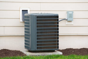 An air conditioning unit installed on a concrete slab outside a home.